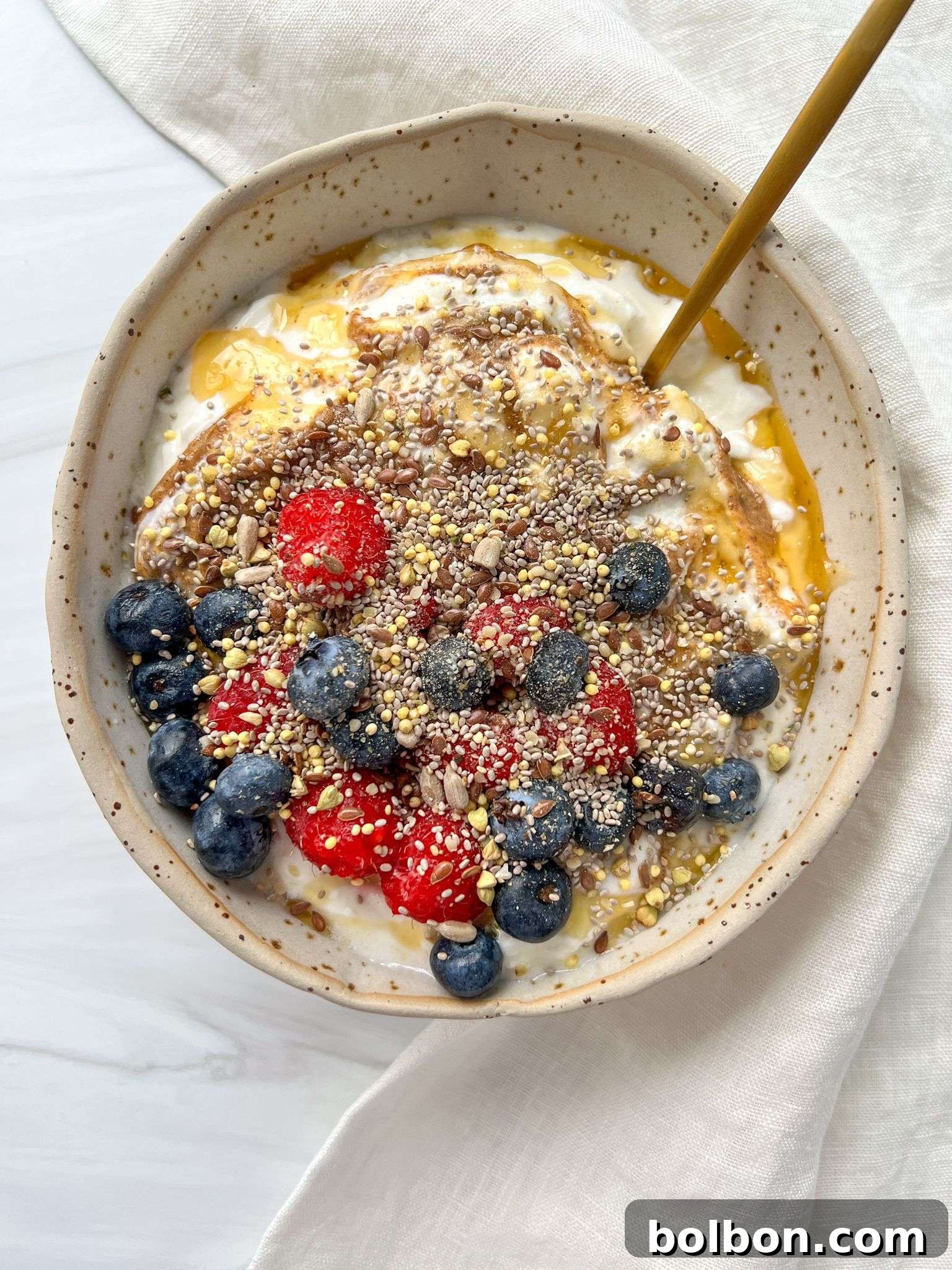 A beautifully arranged Yogurt Bowl with fresh berries, nuts, and a drizzle of honey, ready to be enjoyed as a healthy breakfast.