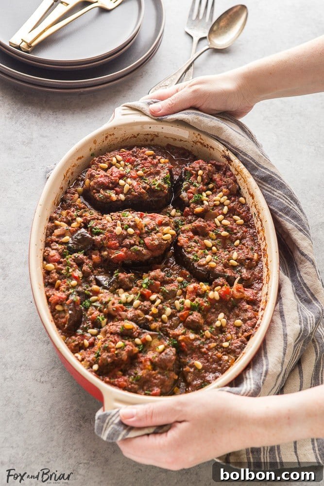 This Meat Stuffed Eggplant (Bitten Jen) is a delicious, hearty, and low-carb Syrian dinner, made with cinnamon-scented lamb, tomatoes, and toasted pine nuts. Perfect for winter and gluten-free diets.