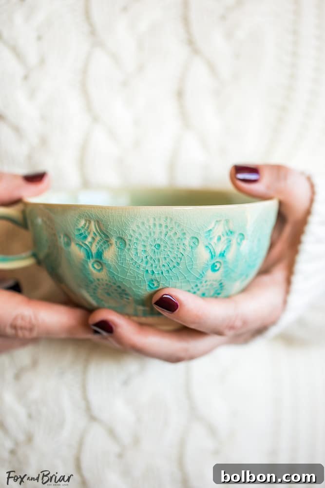 Close-up of hands gently holding a warm cup of homemade chai tea, evoking a feeling of peace and contentment