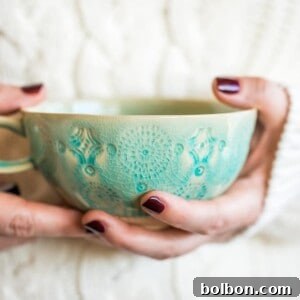 A top-down view of a glass of homemade chai concentrate, showcasing its rich color and inviting aroma