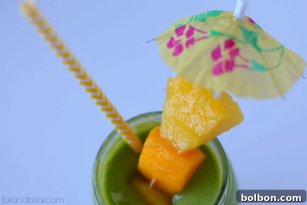 Tropical Green Smoothie in a glass, ready to be enjoyed.