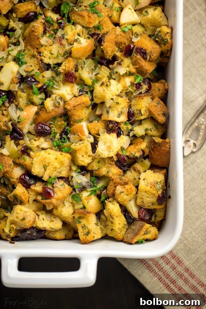 Homemade Cranberry Apple Stuffing with herbs and apples, showcasing its moist texture