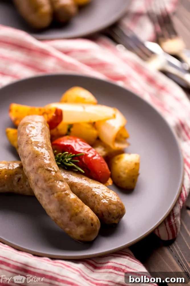 Apples mixed with sausage and potatoes on a sheet pan, ready for roasting, emphasizing a unique flavor combination.