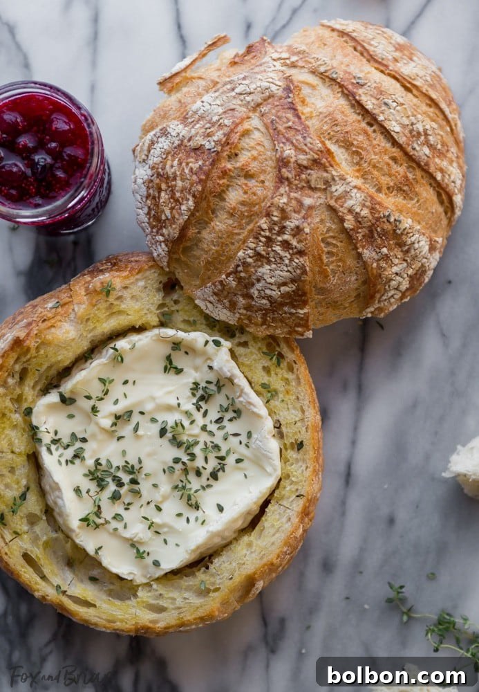 Gooey Cranberry Brie Bread Bowl 3 A delightful shot highlighting the gooey, melted brie cheese and bright cranberry sauce within the ready-to-serve pull-apart bread bowl.