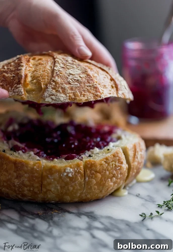 Gooey Cranberry Brie Bread Bowl 4 A beautifully composed image showcasing the elegance and deliciousness of the Baked Cranberry Brie Bread Bowl, ready to impress at any holiday gathering.