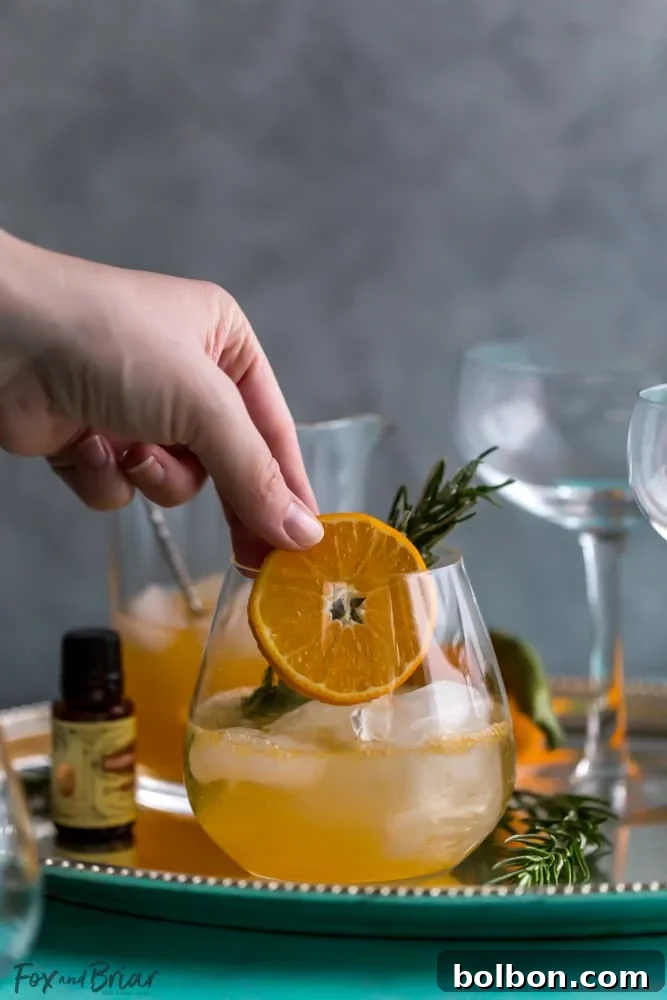 Rosemary Clementine Sparkler Mocktail: A sophisticated non-alcoholic drink for the holidays, featuring rosemary-juniper syrup, fresh clementine juice, and sparkling water. Perfect for pregnancy, dry January, and all festive occasions.