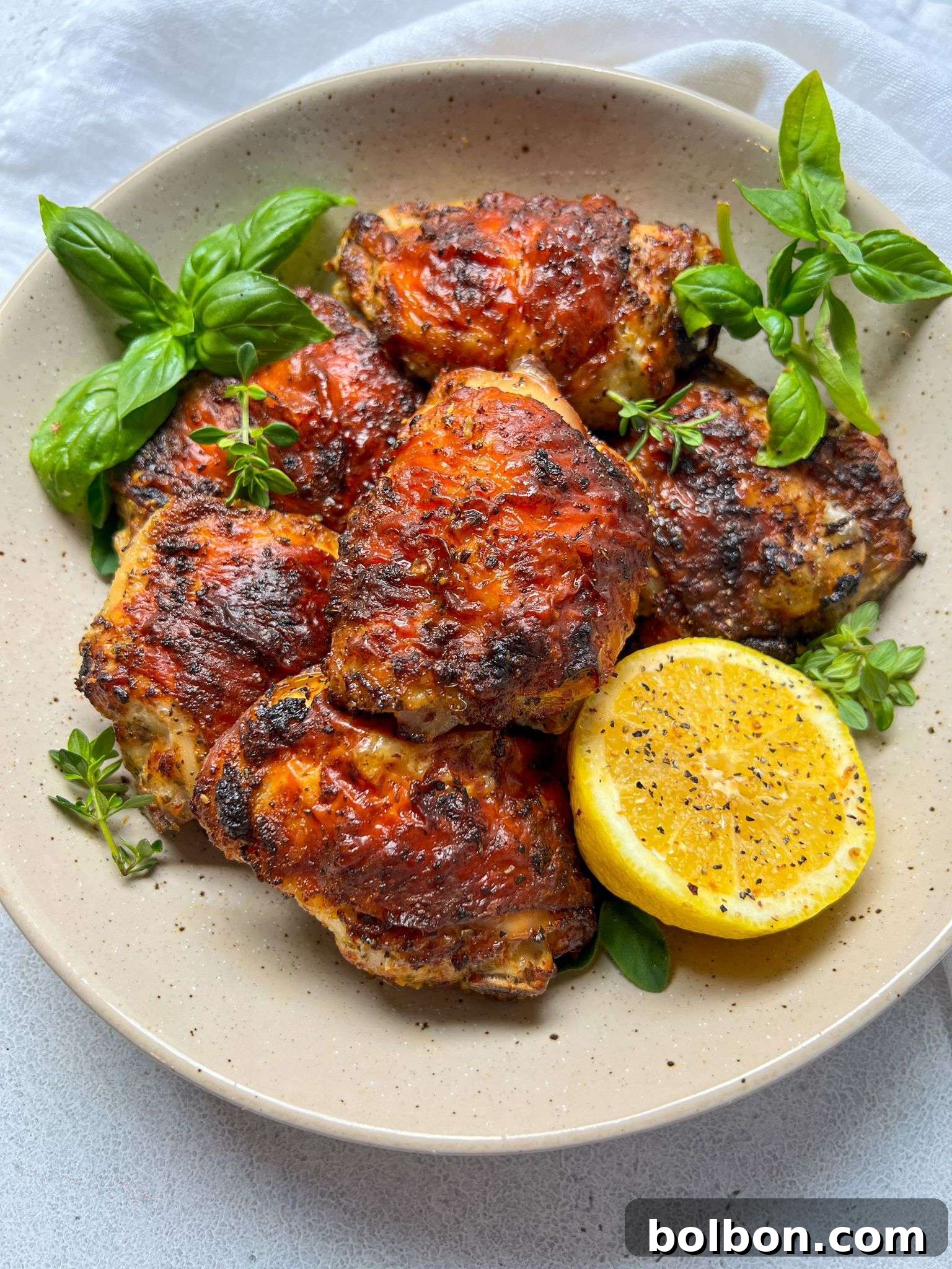 Citrus-Kissed Peppered Chicken 2 Crispy golden-brown Lemon Pepper Chicken thighs, perfectly cooked and ready to serve, highlighting the delicious texture and vibrant color.