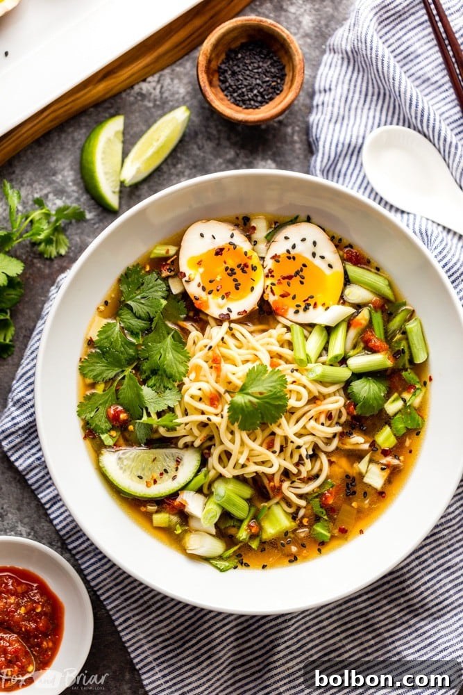 A final, appetizing shot of Instant Pot Chicken Ramen, emphasizing its warmth and the vibrant contrast of fresh toppings against the deep, savory broth. A truly inviting and comforting dish.
