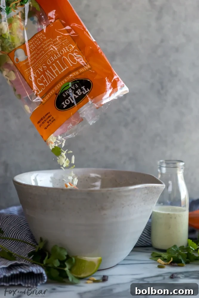 Wholesome Slow Cooker Chicken Tortilla Soup with a Fresh Southwest Salad 6 A vibrant and nutritious Taylor Farms Power Greens Mix, featuring baby spinach and baby kale, ready to be added to the soup.