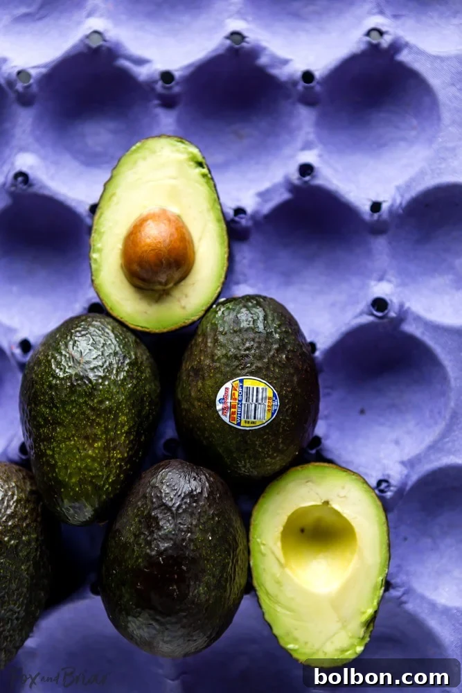Wholesome Slow Cooker Chicken Tortilla Soup with a Fresh Southwest Salad 7 Close-up of freshly sliced Mission Avocados, highlighting their creamy green flesh, ready to top the soup and salad.