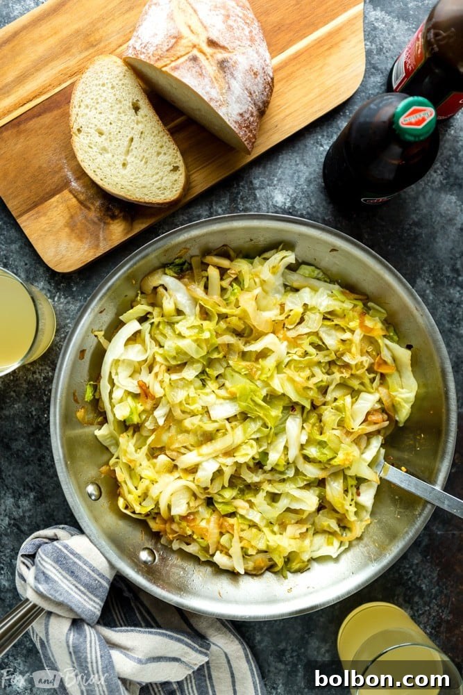 Close-up shot of freshly sliced green cabbage, ready to be sautéed, highlighting the vibrant color.