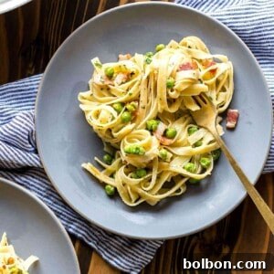 The finished Creamy Pasta with Pancetta and Peas dish, served fresh, showcasing its creamy texture and vibrant ingredients.