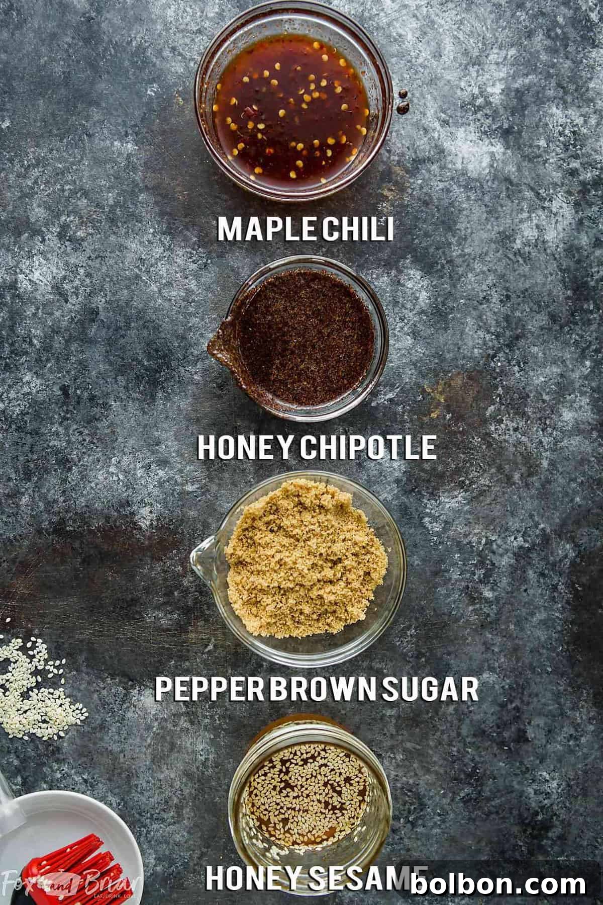 Four distinct piles of flavored bacon: Maple Chili, Honey Chipotle, Pepper Brown Sugar, and Honey Sesame.