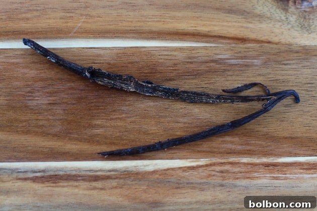 Triple Vanilla Dream 4 Close-up of a vanilla bean pod, split to reveal seeds
