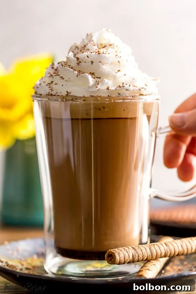 Whip Up a Cozy Brown Sugar Cinnamon Cortado 6 Pouring steamed milk into a Brown Sugar Cinnamon Cortado
