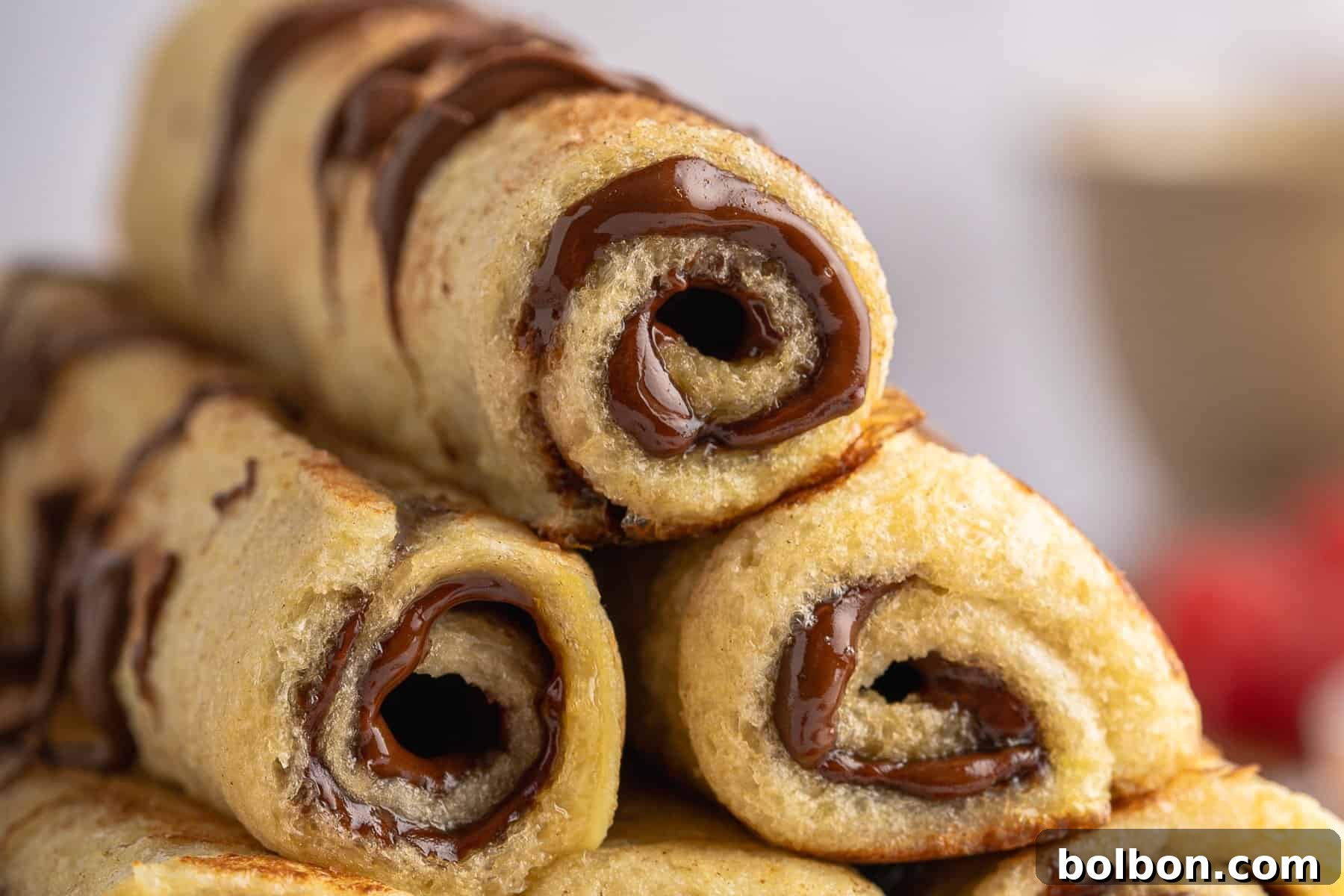 Chocolate-filled French Toast Roll-Ups dusted with cinnamon sugar