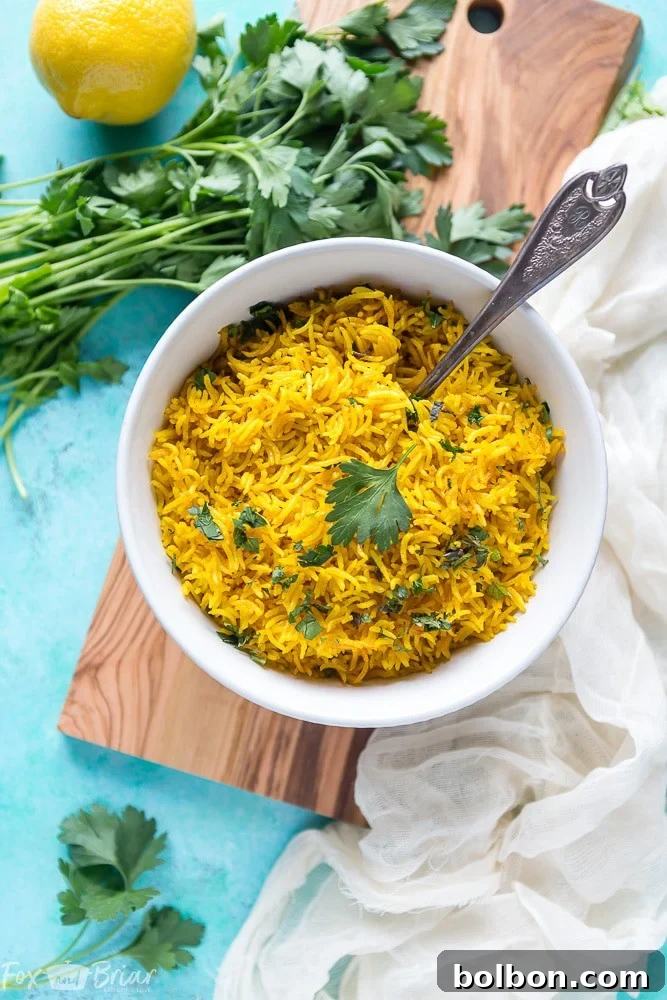 A beautifully plated bowl of vibrant turmeric rice, garnished with fresh herbs, ready to serve as a delicious and healthy side dish.