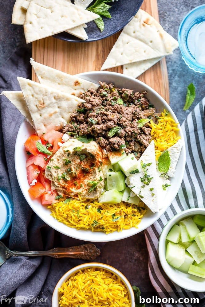 Sun-Kissed Mediterranean Lamb Bowls 4 A top-down view of a Mediterranean Lamb Bowl, showcasing the colorful ingredients arranged neatly and invitingly.