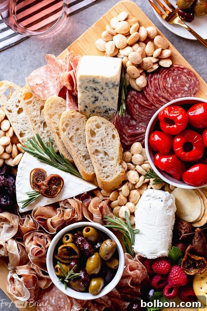 Simple yet elegant small charcuterie board with cheese, meat, and grapes