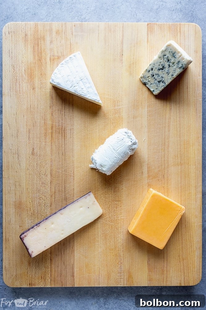 Starting a charcuterie board by placing cheese wedges