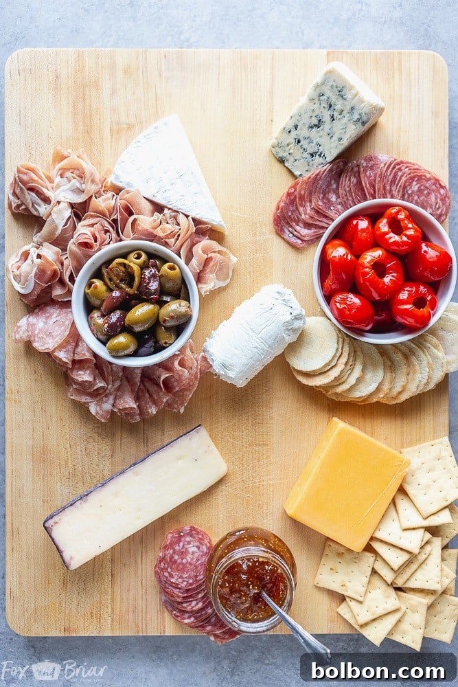 Arranging cured meats like salami and prosciutto on a charcuterie board