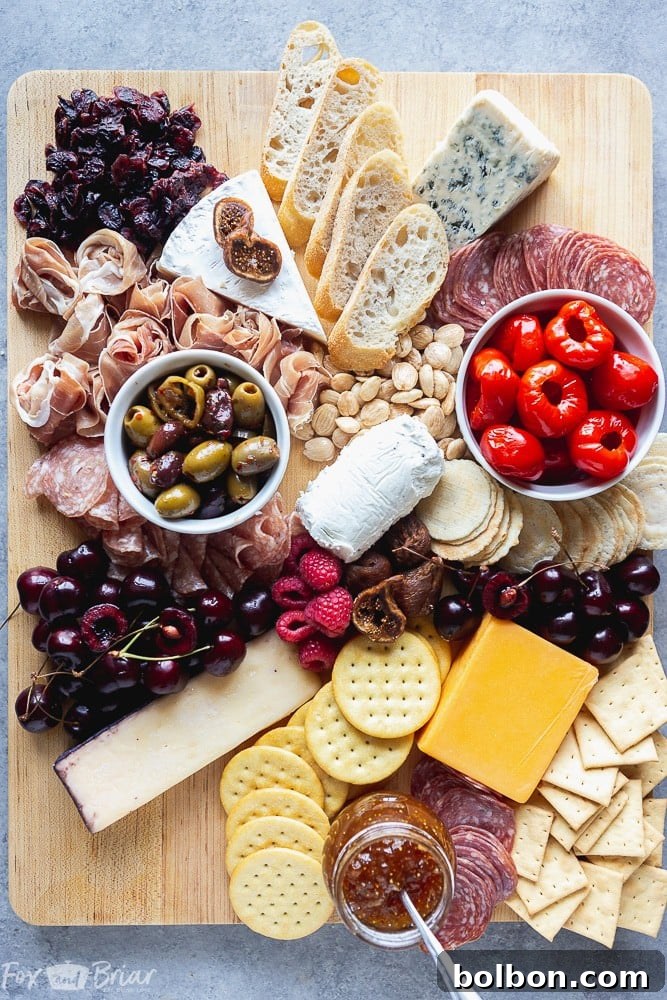 Filling empty spaces with fruits, nuts, and additional small items on a charcuterie board