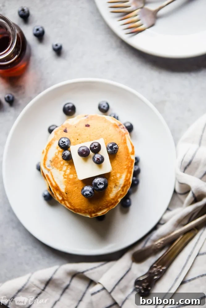 Berry Burst Buttermilk Pancakes 4 Freshly made buttermilk blueberry pancakes drizzled with maple syrup