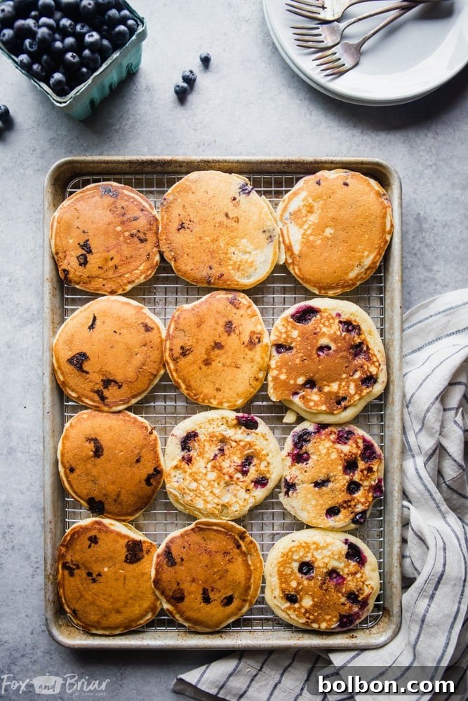 Berry Burst Buttermilk Pancakes 6 Closeup of cooked buttermilk blueberry pancakes with a generous amount of blueberries