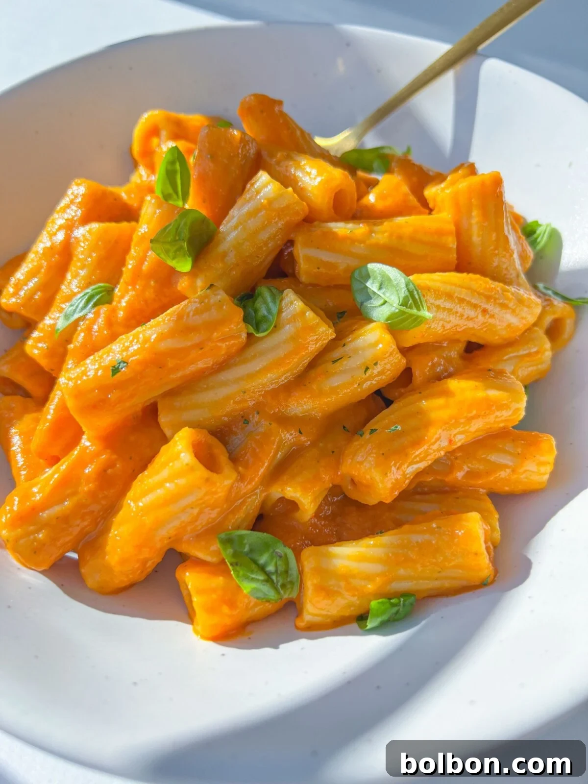 Creamy Hidden Veggie Pasta Sauce served with pasta, garnished with fresh basil.
