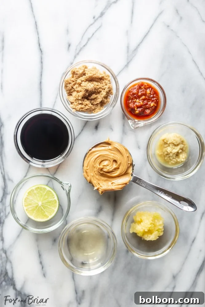 A vibrant stream of Thai Peanut Sauce being drizzled, showcasing its ideal consistency for dressing salads or coating noodles, with rich color and smooth texture.