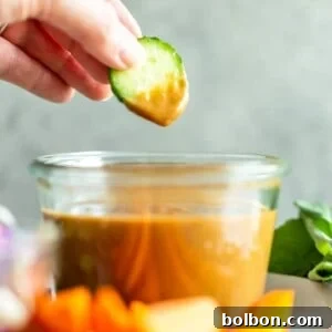 A small bowl of homemade Thai Peanut Sauce, perfect for serving, with a visually appealing presentation.