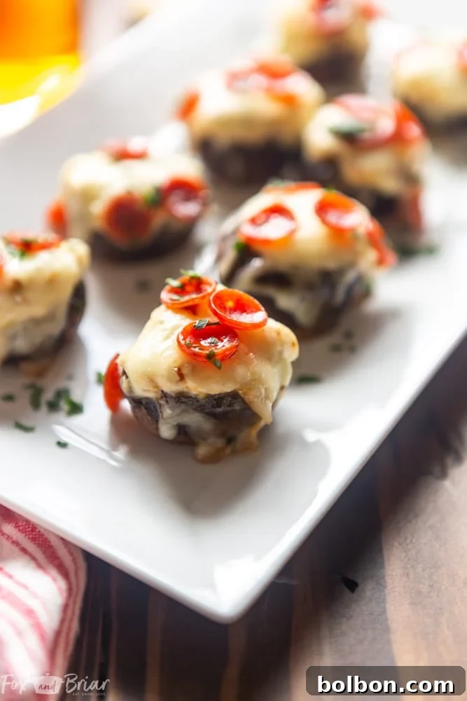 Cheesy Pizza Stuffed Mushrooms 4 A baking sheet filled with freshly baked Pizza Dip Stuffed Mushrooms, hot out of the oven, with melted cheese and crispy pepperoni.