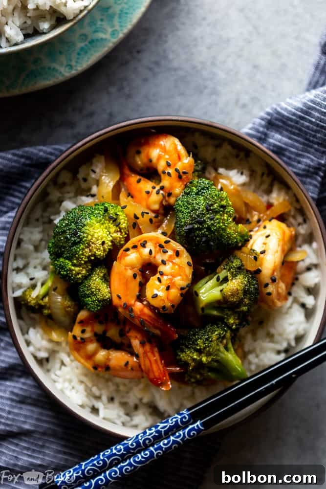 A vibrant close-up of a Quick and Easy Broccoli and Shrimp Stir Fry in a skillet, showcasing succulent shrimp and crisp green broccoli florets coated in a savory sauce. Perfect for healthy dinner ideas and easy stir fry recipes.