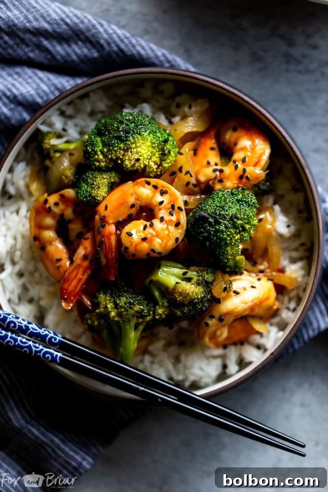 A close-up of fresh, raw shrimp and broccoli florets, showcasing the high-quality ingredients used in this healthy and easy stir fry recipe.