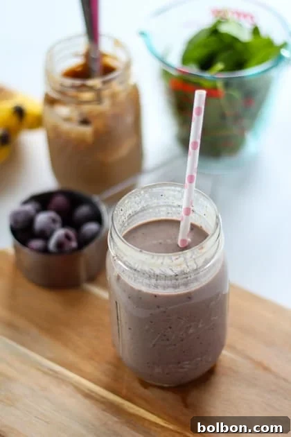 Ingredients for Cherry Almond Green Smoothie laid out on a counter.