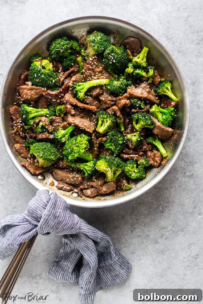 A close-up shot of homemade Beef and Broccoli, emphasizing the glistening sauce coating the tender beef and bright green broccoli, perfect for a quick dinner.