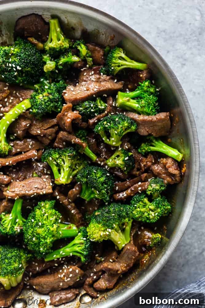 Thinly sliced raw flank steak marinated with tenderizing ingredients, ready for stir-frying in a Beef and Broccoli recipe.