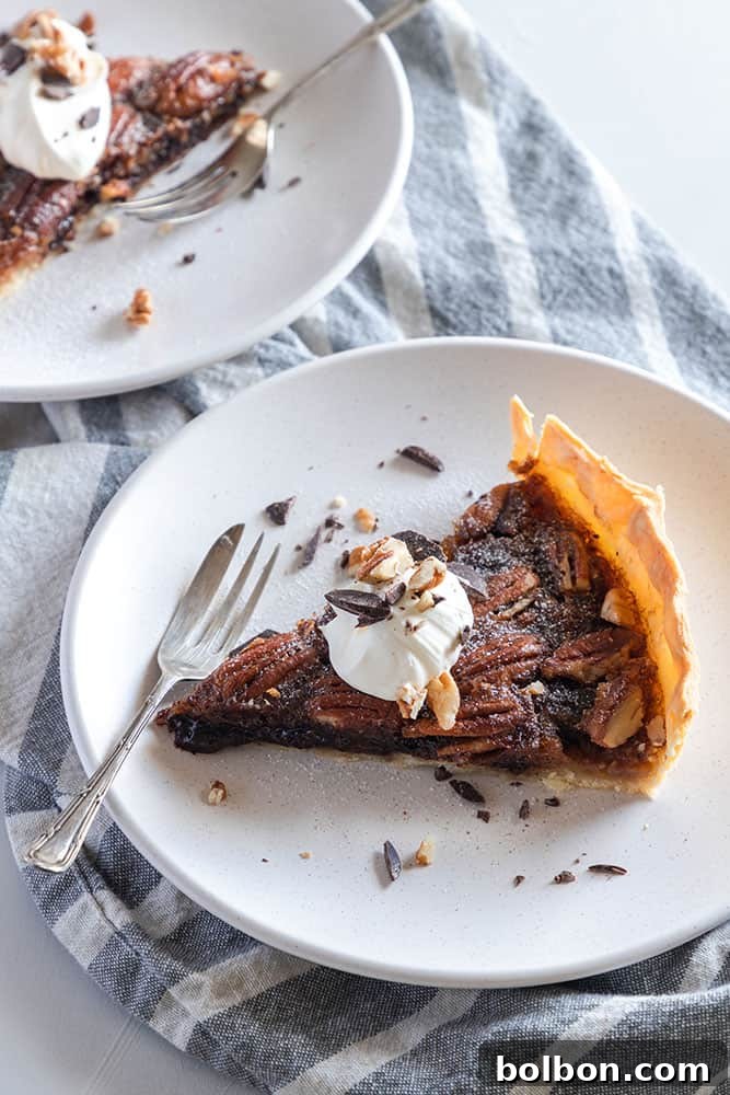 Close-up of a slice of Chocolate Pecan Pie, showing the rich texture