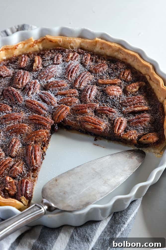 Unbaked Chocolate Pecan Pie with pecans arranged on top, ready for the oven