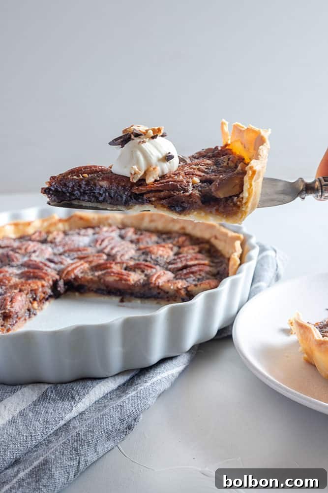 Sliced Chocolate Pecan Pie served with whipped cream and chopped chocolate
