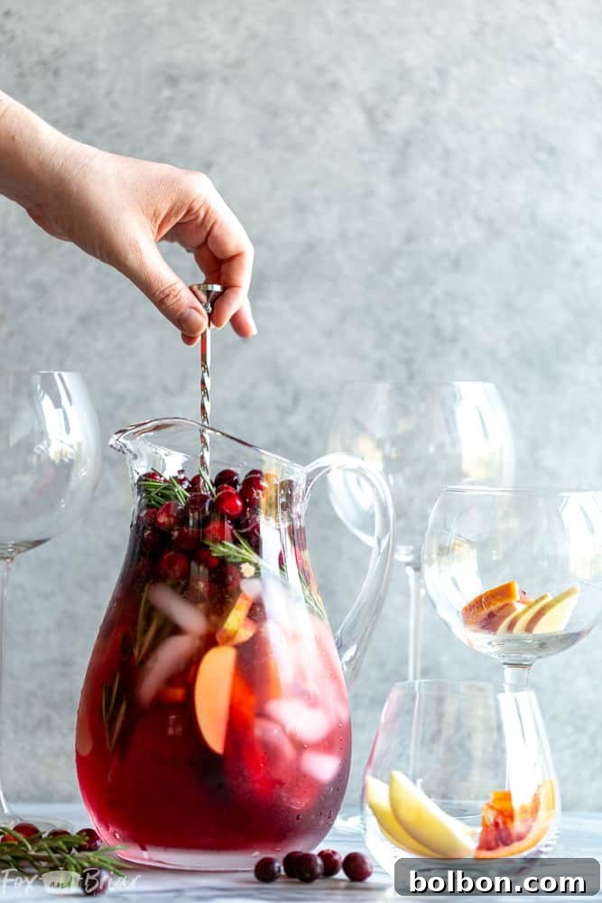 Pouring Cranberry Orange Sangria into a glass