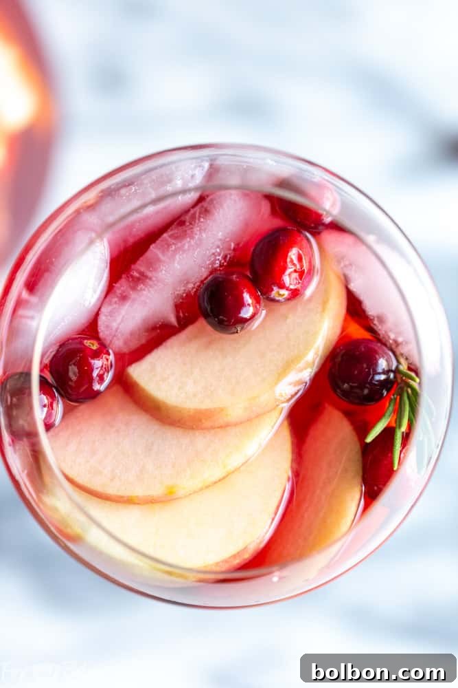 Glasses of Cranberry Orange Sangria on a wooden table