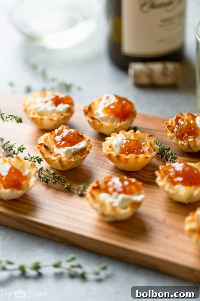 Close-up of golden phyllo cups filled with goat cheese and fig jam