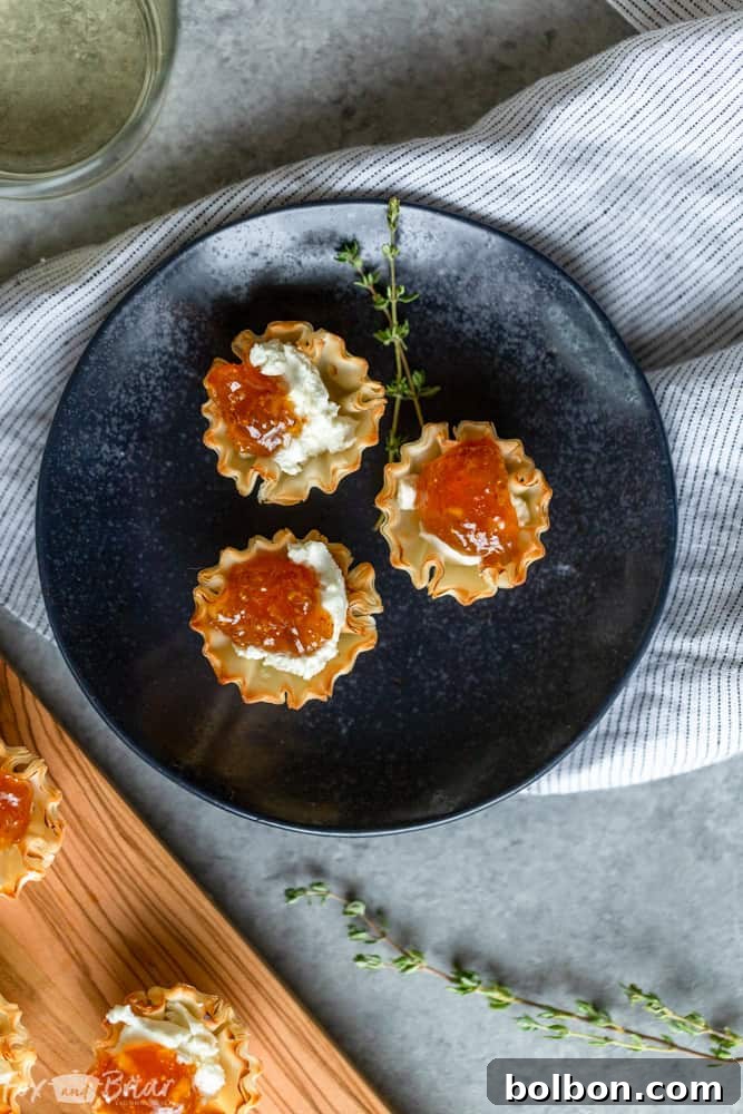 Overhead shot of fig and goat cheese bites arranged on a serving board