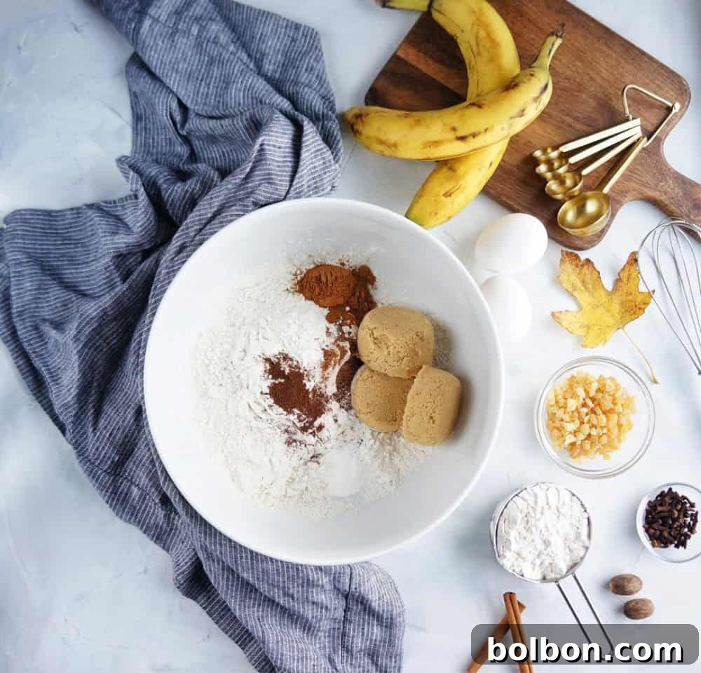 Close-up of freshly baked banana bread, highlighting its moist texture and golden-brown crust, infused with aromatic spices.