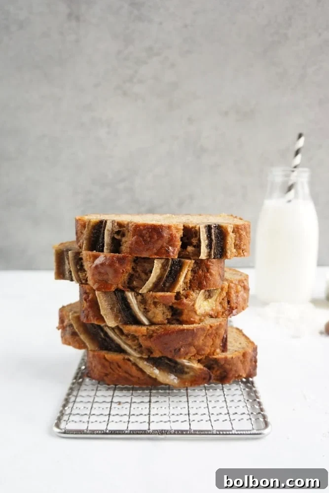 Delicious spiced banana bread sliced and ready to eat, garnished with a banana slice, highlighting its moist interior.
