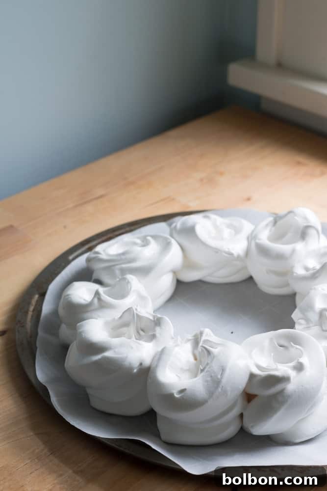 Crafting Your Perfect Pavlova Wreath 5 The fluffy, white meringue mixture in a mixing bowl, perfectly prepared and ready for piping into a festive shape.