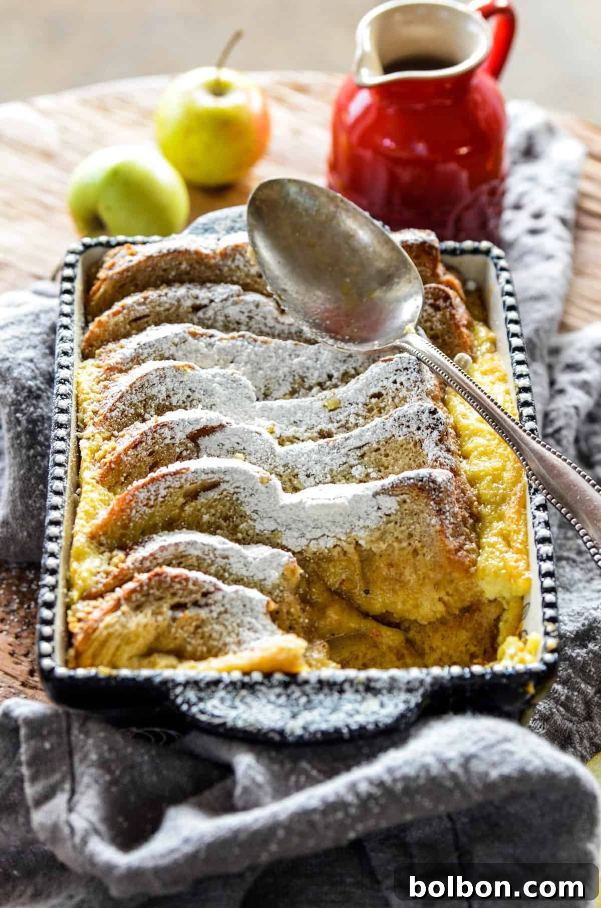Close-up of baked Apple Cardamom Bread Pudding with layers of bread and apples