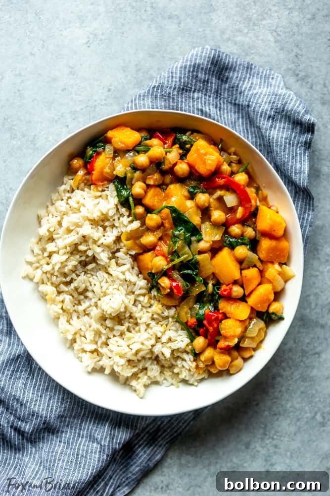Multiple meal prep containers filled with chickpea curry and rice, ready for the week
