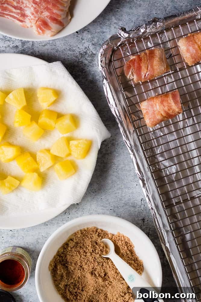 Preparing brown sugar bacon wrapped pineapple bites, showing pineapple chunks drained on paper towels